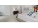 A well-lit primary bedroom shows neutral decor and includes a dark dresser and an adjacent sitting area at 4634 Whitestone Way, Suwanee, GA 30024