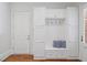 Mudroom featuring built in storage, a bench, and a hardwood floor at 4634 Whitestone Way, Suwanee, GA 30024