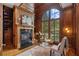 Office with wood paneling, a fireplace, and a large arched window for natural light at 4634 Whitestone Way, Suwanee, GA 30024