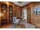 Office featuring built-in bookshelves, wood paneling, and a glass desk for a modern touch at 4634 Whitestone Way, Suwanee, GA 30024