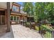A stone tile patio features an outdoor kitchen with a grill, nestled by a well-landscaped backyard at 4634 Whitestone Way, Suwanee, GA 30024