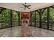 Charming screened-in porch with stone flooring, a stone fireplace, and views of the private backyard at 4634 Whitestone Way, Suwanee, GA 30024