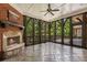 Screened-in porch with a stone fireplace and views of the landscaped backyard, offering outdoor living space at 4634 Whitestone Way, Suwanee, GA 30024