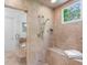 The main bath features a walk-in shower stall with beige tile, a built-in bench, and a window at 4634 Whitestone Way, Suwanee, GA 30024