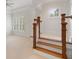Elegant staircase with wood treads and white trim leading to a bright upper level with large windows at 4634 Whitestone Way, Suwanee, GA 30024