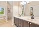 Bright bathroom with double vanity, glass shower, soaking tub, and large mirror at 4771 Summerwood Se Dr, Smyrna, GA 30126