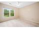 Bright bedroom with a ceiling fan and a large window offering views of the lush greenery outside at 4771 Summerwood Se Dr, Smyrna, GA 30126