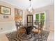 Bright dining room featuring a marble table, elegant chandelier, and large windows overlooking the greenery outside at 4771 Summerwood Se Dr, Smyrna, GA 30126