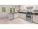 Open-concept kitchen with stainless steel appliances, granite countertops, and stylish cabinetry with a door to the outside at 4771 Summerwood Se Dr, Smyrna, GA 30126