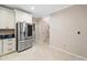 Contemporary kitchen featuring stainless steel appliances, white cabinetry and an adjacent dining area at 4771 Summerwood Se Dr, Smyrna, GA 30126