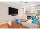 Relaxing living room featuring plush sectional sofa, fireplace and hearth, and a large screen television at 4771 Summerwood Se Dr, Smyrna, GA 30126