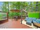 Inviting outdoor deck with comfortable seating, a dining area, and a serene water feature at 4771 Summerwood Se Dr, Smyrna, GA 30126