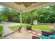 Charming covered patio with ceiling fan and view of the lush, landscaped backyard at 4771 Summerwood Se Dr, Smyrna, GA 30126