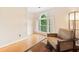 Cozy sitting area featuring a comfortable armchair, hardwood floors, and natural light streaming through the window at 4771 Summerwood Se Dr, Smyrna, GA 30126