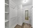Walk-in closet includes wire shelving, a mirror, and access to the main bedroom at 58 Monet Nw Ct, Atlanta, GA 30327