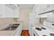 Functional kitchen with white cabinets and appliances, offering ample counter space at 58 Monet Nw Ct, Atlanta, GA 30327