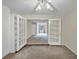 Spacious living room with double doors, offering an airy and connected living space at 58 Monet Nw Ct, Atlanta, GA 30327
