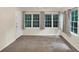Bright living room with large windows and neutral carpet, offering a cozy atmosphere at 58 Monet Nw Ct, Atlanta, GA 30327