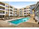 Outdoor swimming pool with lounge chairs surrounded by apartments with balconies at 870 Inman Village Ne Pkwy # 305, Atlanta, GA 30307