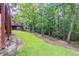 Spacious backyard with a gentle slope, framed by mature trees and a classic fence at 1172 Oakhurst Trl, Lawrenceville, GA 30043