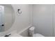 Cozy bathroom with a round mirror, white toilet and modern fixtures, offers comfort and style at 1172 Oakhurst Trl, Lawrenceville, GA 30043