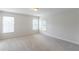 Bright, spacious bedroom with neutral carpeting, three windows and ample natural light at 1172 Oakhurst Trl, Lawrenceville, GA 30043