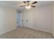 Bedroom with neutral carpeting, ceiling fan, ample space, and a closet with double doors at 1172 Oakhurst Trl, Lawrenceville, GA 30043