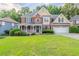 Charming two-story brick home with a welcoming front porch and well-manicured lawn at 1172 Oakhurst Trl, Lawrenceville, GA 30043