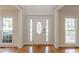 Bright foyer with hardwood floors, a decorative front door, and large windows at 1172 Oakhurst Trl, Lawrenceville, GA 30043