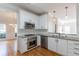 Bright kitchen with white cabinets, stainless steel appliances, and granite countertops at 1172 Oakhurst Trl, Lawrenceville, GA 30043