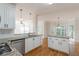 Open kitchen with a central island, white cabinetry, and stainless steel dishwasher at 1172 Oakhurst Trl, Lawrenceville, GA 30043