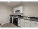 Efficient kitchen featuring white cabinets, black appliances, and durable countertops for functionality at 1172 Oakhurst Trl, Lawrenceville, GA 30043