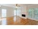 Spacious living room with hardwood floors, a fireplace, and bright natural light at 1172 Oakhurst Trl, Lawrenceville, GA 30043