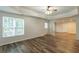 Open-concept living room boasts wood floors, coffered ceilings, large windows, and a ceiling fan at 1172 Oakhurst Trl, Lawrenceville, GA 30043