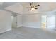 Spacious main bedroom featuring neutral carpeting, tray ceilings, and an ensuite bath at 1172 Oakhurst Trl, Lawrenceville, GA 30043