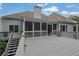 An inviting screened-in back porch with gray wood, attached to a home with light gray siding at 130 Holly Reserve Pkwy, Canton, GA 30114