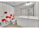 Cozy bathroom with white cabinets, large mirror, white shower curtain with a poppy design at 130 Holly Reserve Pkwy, Canton, GA 30114