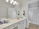 Bright, clean bathroom featuring white cabinets, a large mirror, and a shower with a white curtain at 130 Holly Reserve Pkwy, Canton, GA 30114