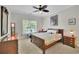 Bedroom with wood furniture, soft neutral carpet, and a bright window with a tree view at 130 Holly Reserve Pkwy, Canton, GA 30114