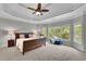 A stylish bedroom featuring tray ceilings and large windows offering ample natural light at 130 Holly Reserve Pkwy, Canton, GA 30114