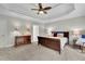 Cozy bedroom with a wood sleigh bed, rocking chair, and ample space for a comfortable retreat at 130 Holly Reserve Pkwy, Canton, GA 30114