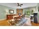 Traditional dining room with a stone fireplace, large window, and elegant decor at 130 Holly Reserve Pkwy, Canton, GA 30114