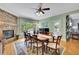 Inviting dining room with a stone fireplace, hardwood floors, and ample natural light at 130 Holly Reserve Pkwy, Canton, GA 30114
