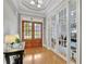 Bright entryway with hardwood floors, complemented by glass paneled doors, offering an inviting view of the interior at 130 Holly Reserve Pkwy, Canton, GA 30114