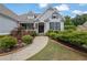 Beautiful home with a well-maintained yard, showcasing mature landscaping and a welcoming walkway to the front entrance at 130 Holly Reserve Pkwy, Canton, GA 30114