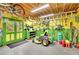 Organized garage with pegboard walls, green doors, lawnmower, and tools at 130 Holly Reserve Pkwy, Canton, GA 30114