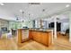 Open-concept kitchen with stainless steel appliances, a breakfast bar, and seamless flow into the dining area at 130 Holly Reserve Pkwy, Canton, GA 30114