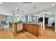 Open-concept kitchen with hardwood floors, granite countertops, and a seamless view into the adjacent dining room at 130 Holly Reserve Pkwy, Canton, GA 30114