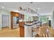 A kitchen with an island bar, wood cabinets, and stainless steel appliances at 130 Holly Reserve Pkwy, Canton, GA 30114