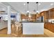 Bright, open kitchen features a granite island with seating and stainless steel appliances at 130 Holly Reserve Pkwy, Canton, GA 30114